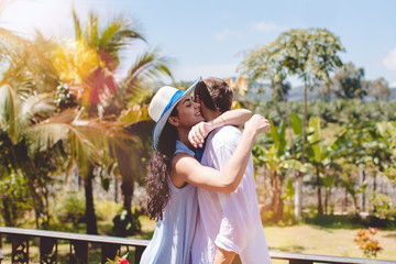 Happy Man And Woman Hugging On Terrace Or Balcony With Beautiful Tropical Landscape Young Couple Embrace Outdoors