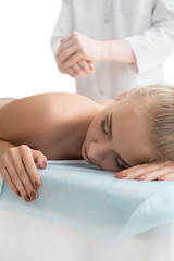 Obraz na płótnie Canvas Male massagist making massage to blonde in spa