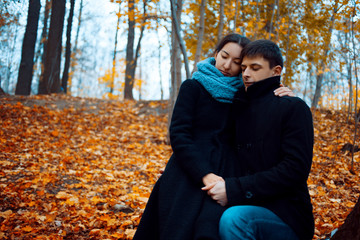 Young man and woman in warm autumn clothes, cashmere coat