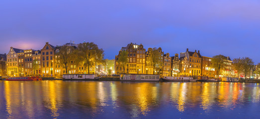 Fototapeta na wymiar Amsterdam sunset panorama city skyline at canal waterfront, Amsterdam, Netherlands