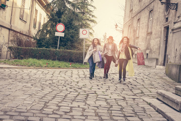 Three best friends walking on the street . Girls on street.