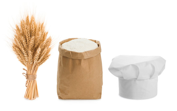 Sheaf of wheat, chefs hat and flour isolated on white