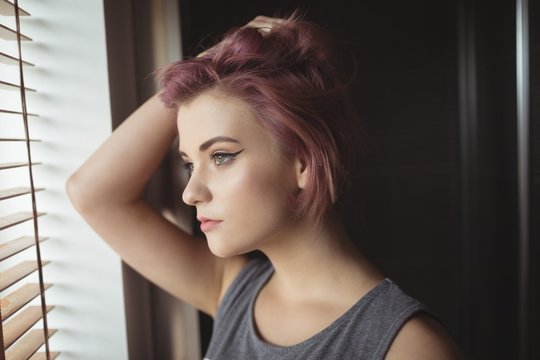 Thoughtful Woman Looking Through Window