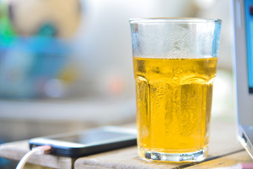 Glass beer on wood table.