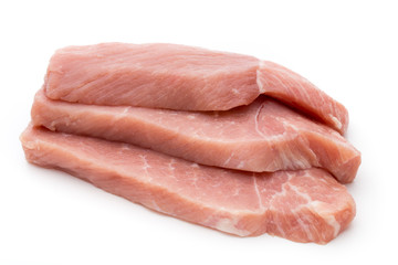 Fresh pork fillet with basil on a white background.