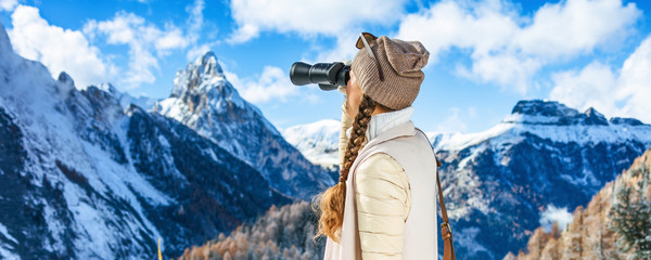 traveller woman looking into the distance through binoculars