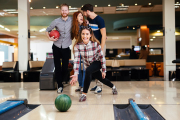 Friends bowling at club