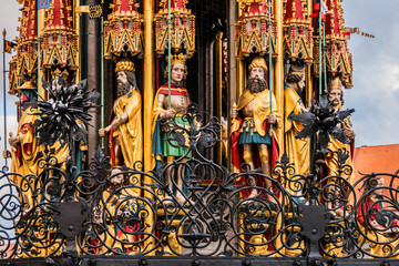 Fototapeta premium Detail of Beautiful fountain (Schoner Brunnen) and statue. 19 meters high Schoner Brunnen - 14th-century fountain located on Nuremberg's main market, built by Heinrich Beheim. Nuremberg, Germany.
