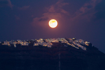 Full moon over Imerovigli town on Santorini island, Greece.
