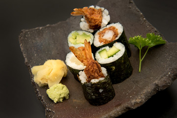 Sushi maki rolls with salmon, avocado and prawns