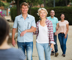 mature males and females walking on holiday