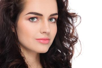 Fototapeta premium Young beautiful woman with fresh clean make-up and curly hair over white background, copy space