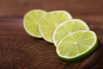 Lime slices on a dark plate