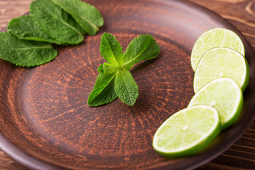 Lime slices and mint leaves