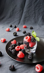 black berries and raspberries in a glass cup