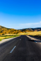 road through the mountain ,summer time ,sunny day ,blue sky