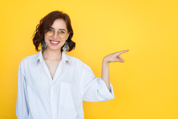 Woman in glasses pointing with finger
