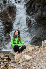 woman enjoying near a waterfall
