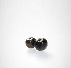 Dried preserved or Black Plums on a background.