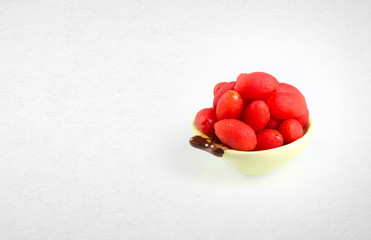 Dried preserved red canarium album on a background.