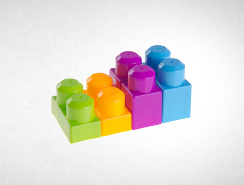 Plastic building blocks or colour blocks on a background.