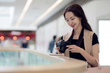 Young beautiful woman photographer, in the interior of the store