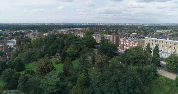 Aerial panning view over residential Victorian villages by the river Thames in West London