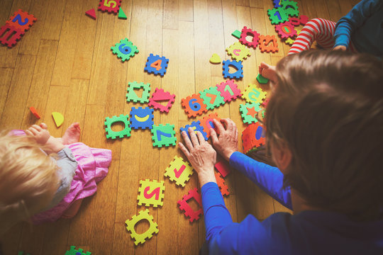 teacher and kids playing with puzzle, early child development