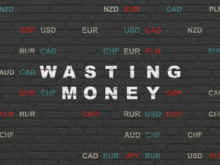 Banking concept: Wasting Money on wall background