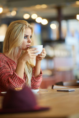 Woman drinking cappuccino