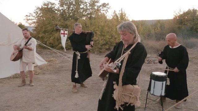 Perfomance medieval ensemble of monks Templars