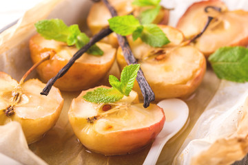 Baked red apples with vanilla syrop, mint and honey