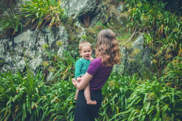 Obraz premium Mother holding baby in nature