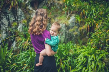 Mother holding baby in nature