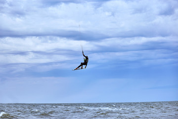 Fototapeta na wymiar Kite Surfing on waves at sea in summer.