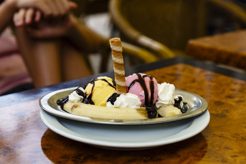 ice cream with bananas and different fruit flavors on a table