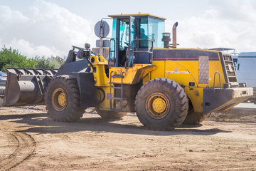 Yellow Wheel Loader building machine with blue sky