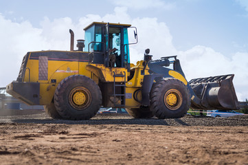 Yellow Wheel Loader building machine with blue sky