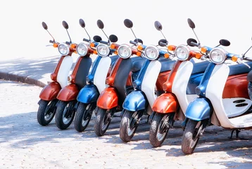 Foto op Plexiglas Colorful moped scooter parking. Transport wheel. Summer sunlight flare. © Valentin Kundeus