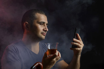 Concept man and technology, a man gets information in the form of smoke from the phone