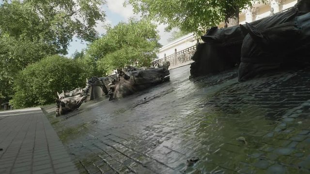 View of water falling down in fountain with horses's heads