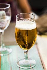 a glass of beer on a table