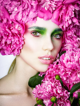Beautiful girl with Creative make-up. Color makeup, studio photo, photo processing, Women and peonies. Art. Retouch skin.