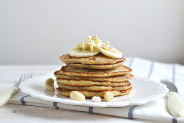 Homemade Banana Cashew Pancakes Honey Sauce Milk Flour Wooden Table Kitchen Towel Cutlery 
