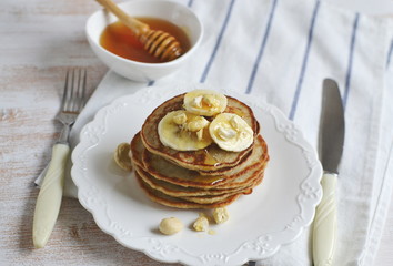 Homemade Banana Cashew Pancakes Honey Sauce Milk Flour Wooden Table Kitchen Towel Cutlery 