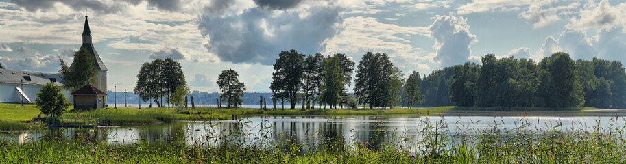 Fototapeta premium Summer panorama of the lake with an Orthodox monastery