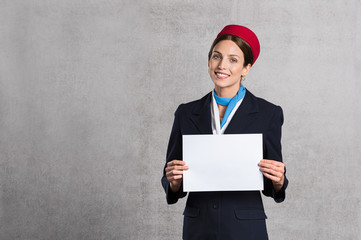 Flight assistant holding white sign