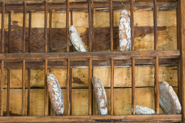 homemade rustic bread in the wall bracket hanging from the wooden wall