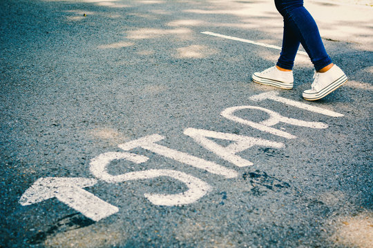 Feet of women with start word on road concept keep going ,hipster tone