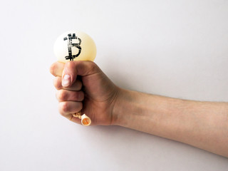 The man's hand holds boosted balloon with the bitcoin symbol on it. Symbol of force boosted bubble collapse of that currency 
